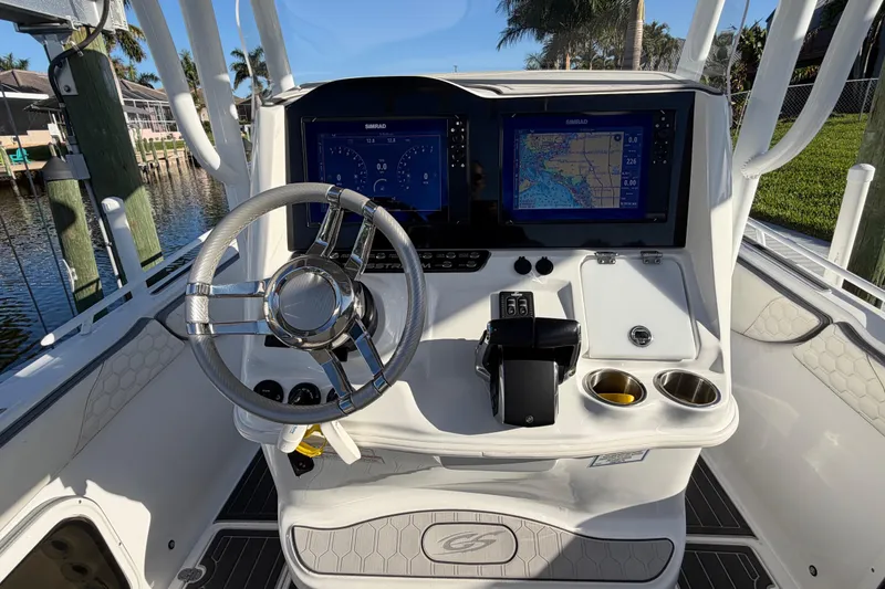 Slide: The Image of 2022 Glasstream 328 Pro-XS boat dashboard with dual Simrad displays and steering wheel. - 13