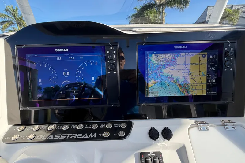 Slide: The Image of 2022 Glasstream 328 Pro-XS dashboard with dual Simrad displays and navigation controls. - 14