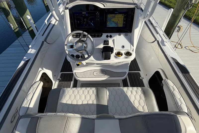 Slide: The Image of 2022 Glasstream 328 Pro-XS boat cockpit with modern steering and navigation displays. - 15
