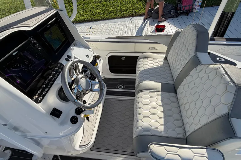 Slide: The Image of 2022 Glasstream 328 Pro-XS boat interior with modern dashboard and hexagonal-patterned seating. - 16