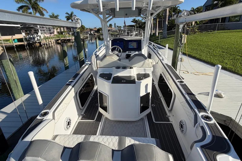 Slide: The Image of 2022 Glasstream 328 Pro-XS boat docked, featuring sleek interior and advanced navigation system. - 21