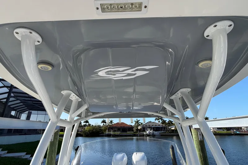 Slide: The Image of 2022 Glasstream 328 Pro-XS boat canopy with logo, overlooking waterfront homes. - 34