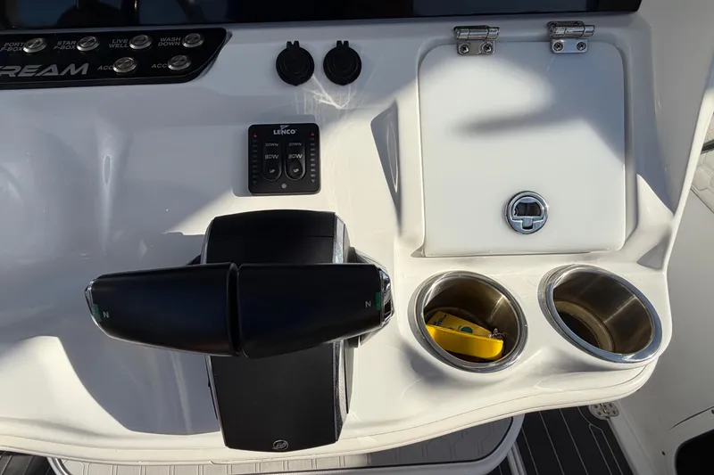 Slide: The Image of 2022 Glasstream 328 Pro-XS boat console with controls, cup holders, and storage compartment. - 35