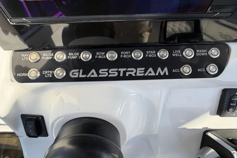 Slide: The Image of Control panel of 2022 Glasstream 328 Pro-XS boat with labeled switches and buttons. - 36