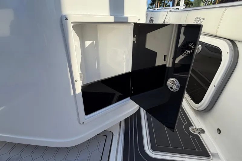 Slide: The Image of 2022 Glasstream 328 Pro-XS boat storage compartment with open black door. - 45