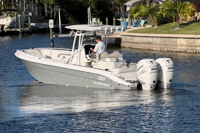 Slide: The Image of 2022 Glasstream 328 Pro-XS boat cruising on a sunny waterway. - 5