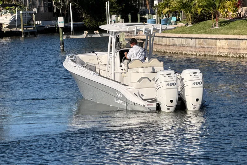 Slide: The Image of 2022 Glasstream 328 Pro-XS boat with dual Mercury 400 engines on a calm waterway. - 6