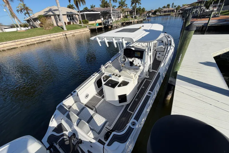 Slide: The Image of 2022 Glasstream 328 Pro-XS boat docked in a scenic canal setting. - 8