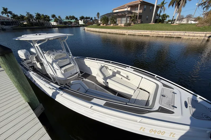 Slide: The Image of 2022 Glasstream 328 Pro-XS boat docked on a sunny waterfront. - 9