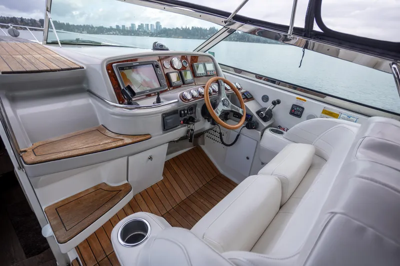 Slide: The Image of 2005 Formula 400 Super Sport boat cockpit with wooden accents and modern controls. - 10