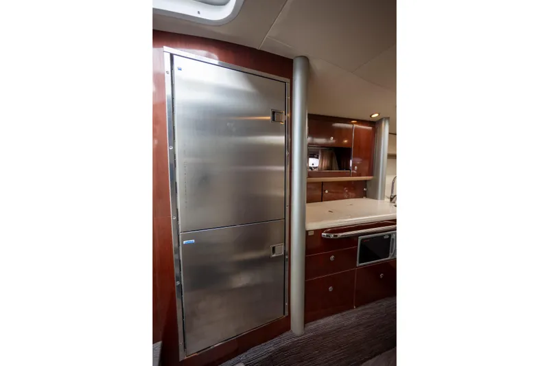 Slide: The Image of 2005 Formula 400 Super Sport yacht interior with stainless steel fridge and wooden cabinetry. - 13