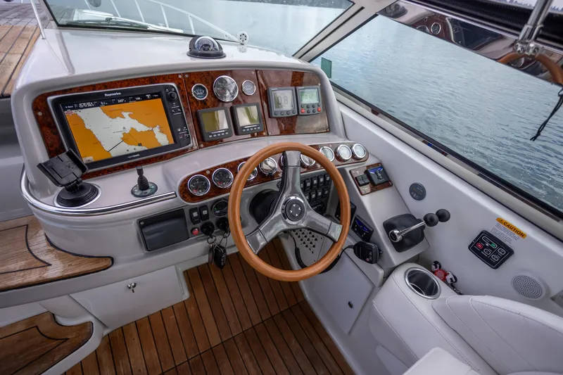 Slide: The Image of 2005 Formula 400 Super Sport boat cockpit with navigation system and wooden steering wheel. - 8