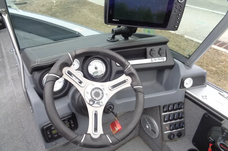 Slide: The Image of Steering console of 2016 Lund 2175 Pro-V boat with gauges and controls. - 10