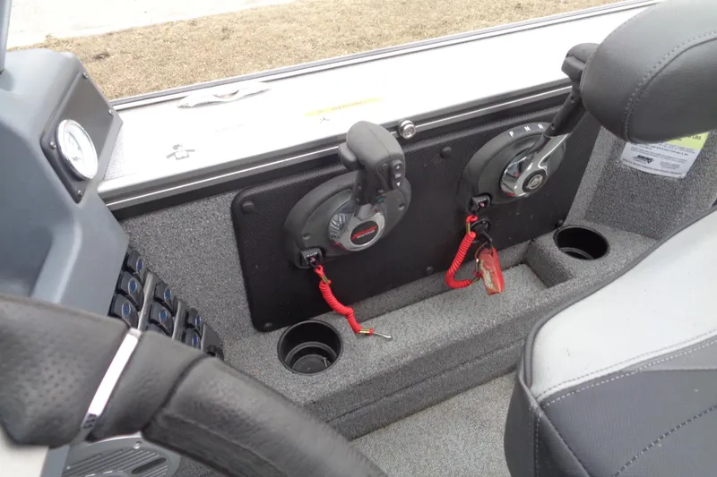 Slide: The Image of 2016 Lund 2175 Pro-V boat interior with steering wheel and control panel. - 12