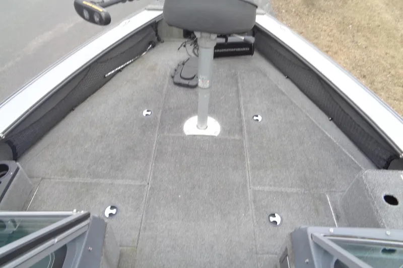 Slide: The Image of 2016 Lund 2175 Pro-V boat interior with gray carpet and seating. - 15