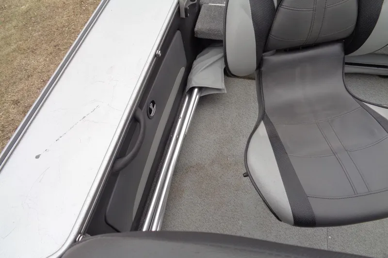 Slide: The Image of 2016 Lund 2175 Pro-V boat interior with gray seating and storage compartment. - 18