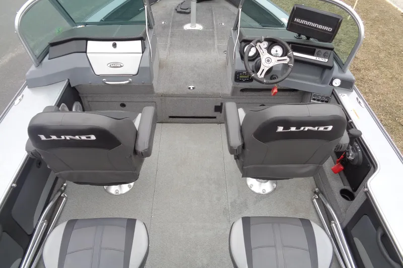 Slide: The Image of 2016 Lund 2175 Pro-V boat interior with steering console and seating. - 7