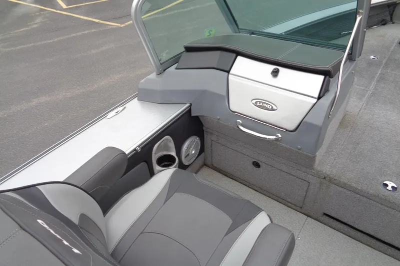 Slide: The Image of 2016 Lund 2175 Pro-V boat interior with gray seating and storage compartments. - 9