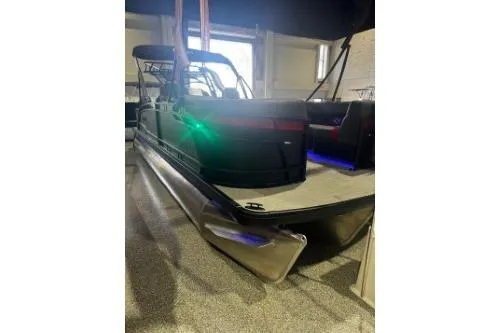 The Image of 2026 Godfrey Monaco 235 SFLC pontoon boat in showroom, featuring sleek design and modern amenities. - 1