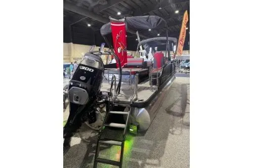 Slide: The Image of 2026 Godfrey Monaco 235 SFLC pontoon boat with powerful 300 HP engine displayed indoors. - 7