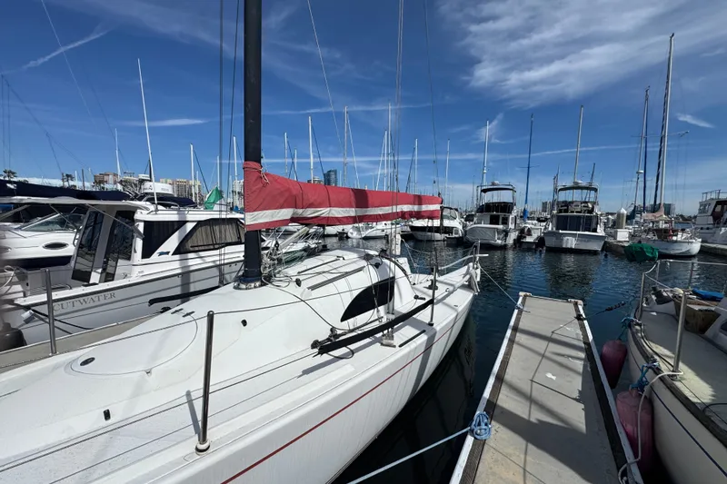 Slide: The Image of Sailboat Flying Tiger 10M, 2007 model, docked in a marina under a clear blue sky. - 1