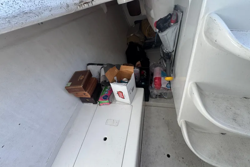 Slide: The Image of Storage compartment of a 2007 Flying Tiger 10M boat with various supplies and boxes. - 18