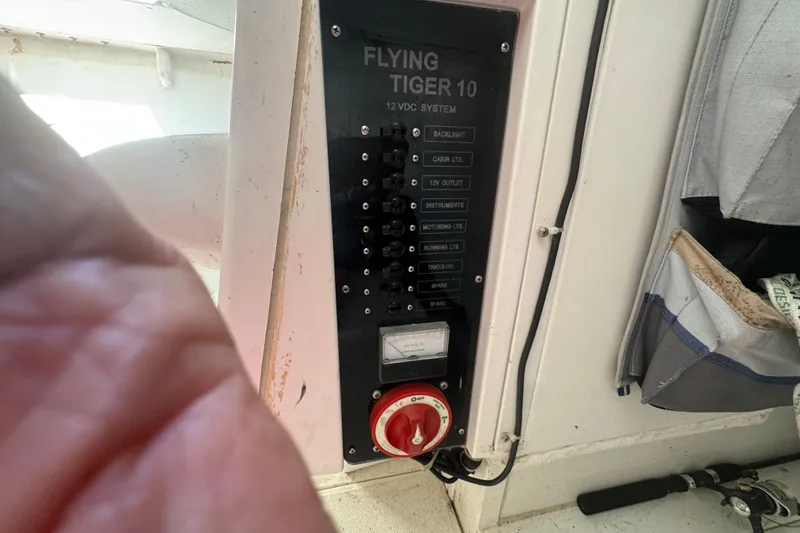 Slide: The Image of Control panel of a 2007 Flying Tiger 10M sailboat, featuring 12V DC system switches. - 20