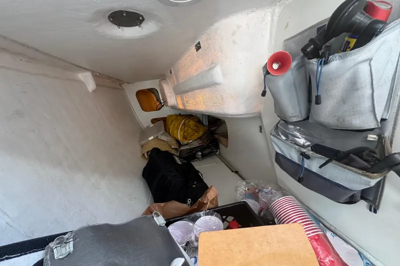 Slide: The Image of Interior of a 2007 Flying Tiger 10M sailboat with storage and supplies. - 22