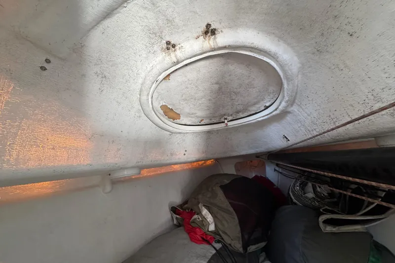 Slide: The Image of Interior of a 2007 Flying Tiger 10M sailboat with visible hatch and storage area. - 29