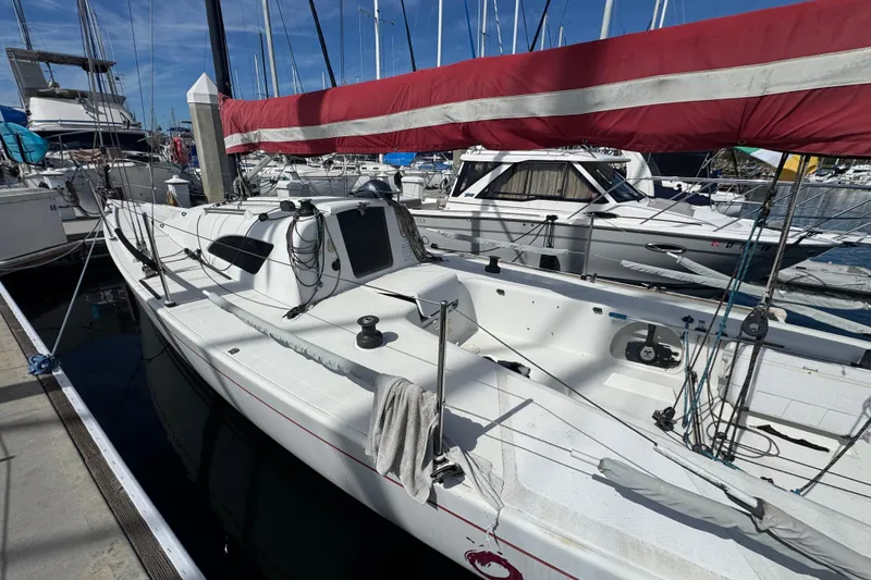 Slide: The Image of Sailboat docked at marina, Flying Tiger 10M, 2007 model, with red sail cover. - 3