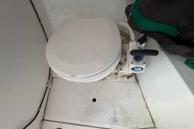 Slide: The Image of Boat toilet in a 2007 Flying Tiger 10M, featuring a manual pump handle. - 30