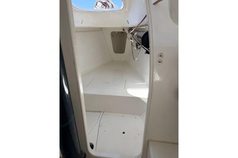 Slide: The Image of Interior view of a 2007 Flying Tiger 10M sailboat, showcasing clean white surfaces. - 34