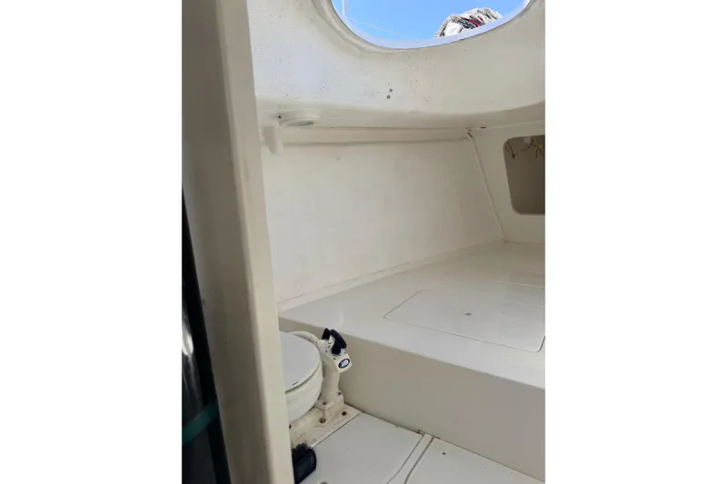 Slide: The Image of Interior of a 2007 Flying Tiger 10M sailboat, featuring a compact marine toilet. - 36