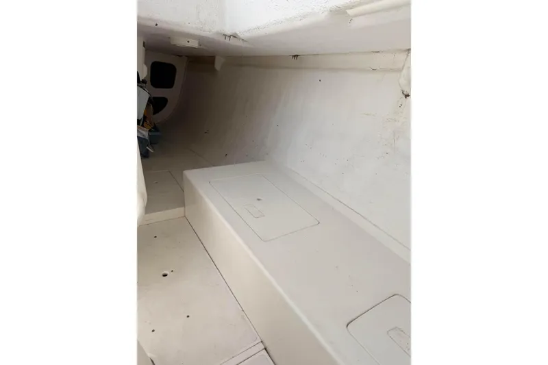 Slide: The Image of Interior of a 2007 Flying Tiger 10M sailboat, featuring a minimalist white cabin design. - 38