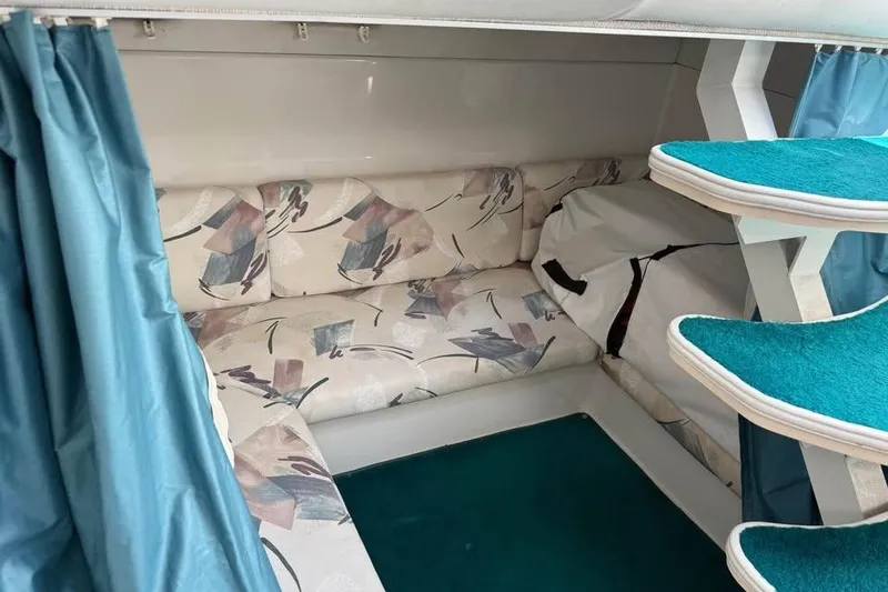 Slide: The Image of Interior of 1995 Chris Craft 34 Crowne with patterned seating and teal accents. - 6