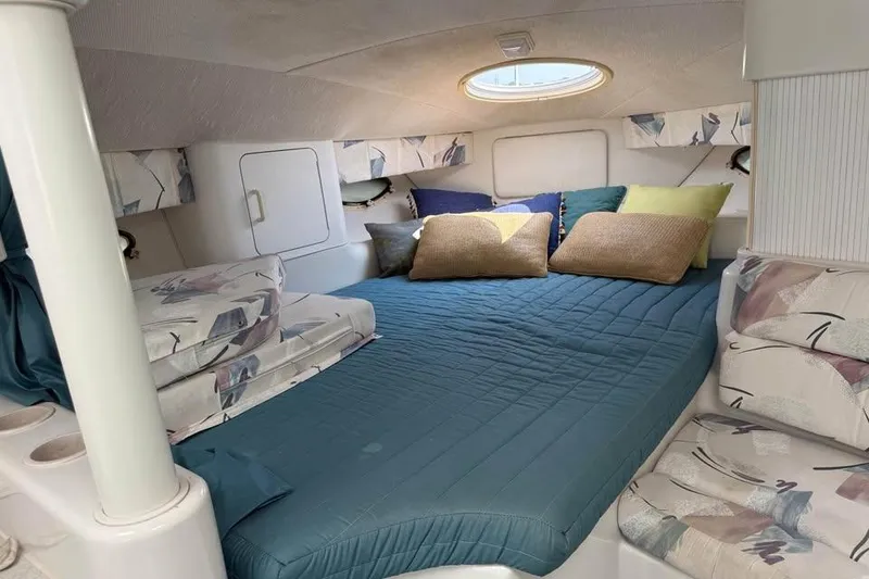 Slide: The Image of Cozy cabin interior of 1995 Chris Craft 34 Crowne with comfortable bedding and cushions. - 9