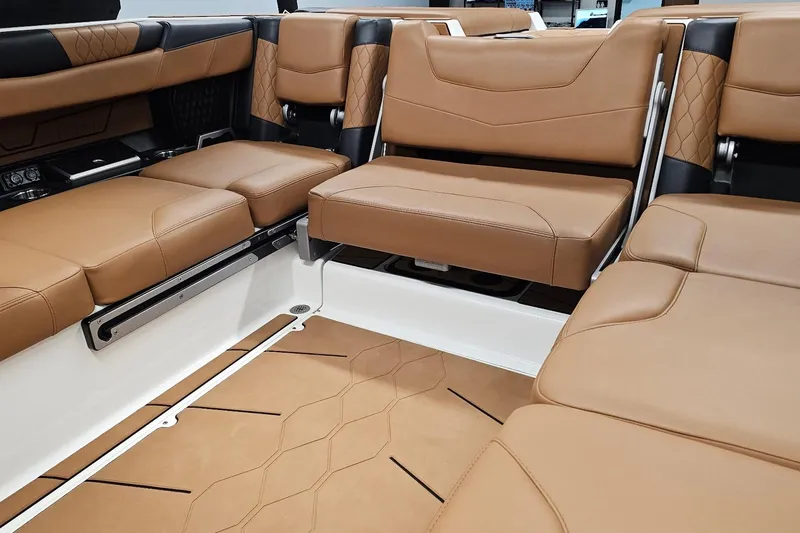 Slide: The Image of 2023 Malibu M220 boat interior with luxurious tan leather seating and modern design. - 10