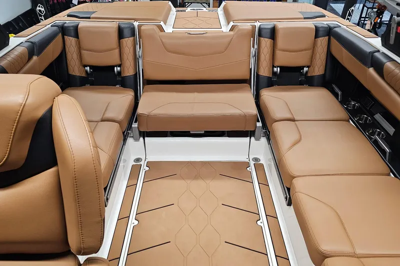 Slide: The Image of 2023 Malibu M220 boat interior with luxurious tan leather seating and modern design. - 11