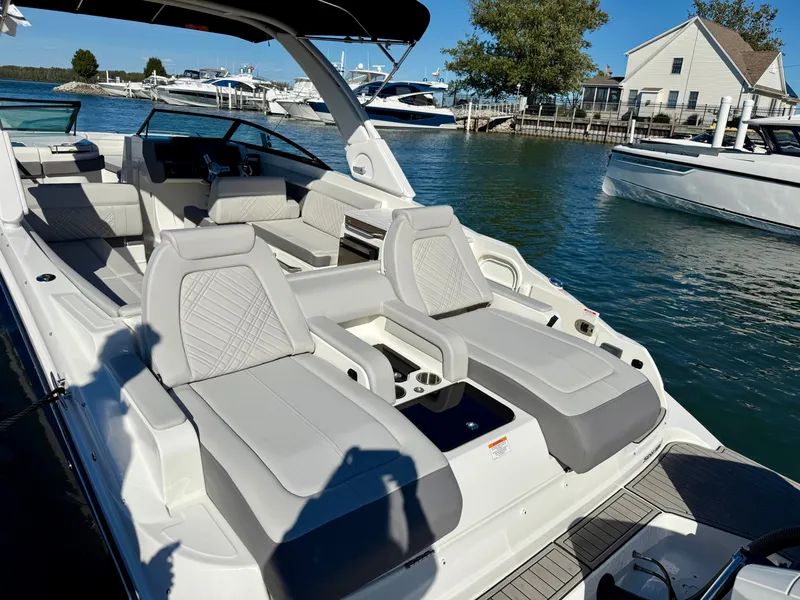 Slide: The Image of The image shows a 2026 Sea Ray SDX 290 Outboard boat with luxurious seating at a marina. - 5