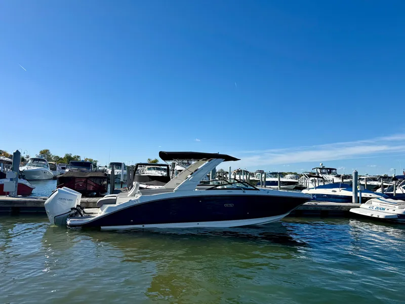 Slide: The Image of A 2026 Sea Ray SDX 290 Outboard is docked in the water. - 1