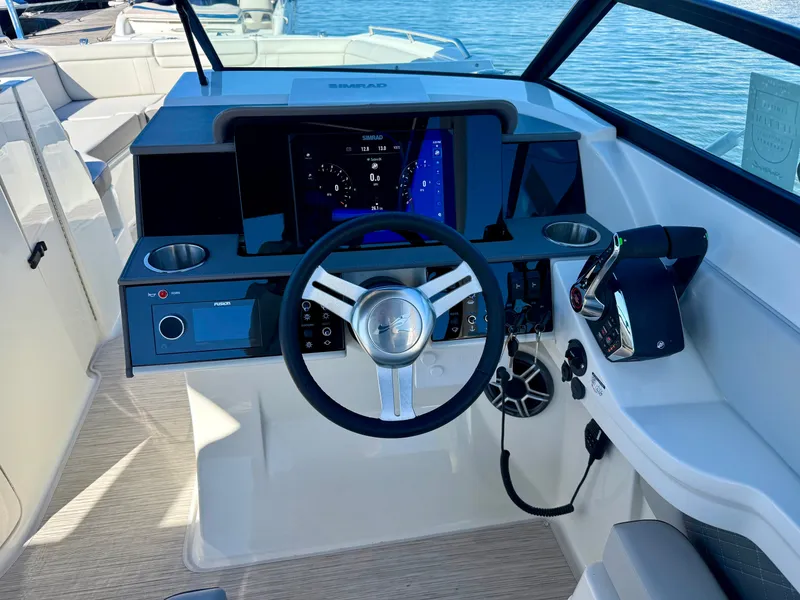 Slide: The Image of The 2026 Sea Ray SDX 290 Outboard cockpit features a modern helm with touchscreen controls. - 12