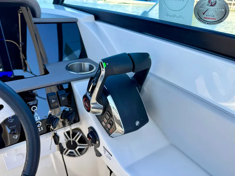 Slide: The Image of Helm of the Sea Ray SDX 290 Outboard with modern controls and a cup holder. - 14