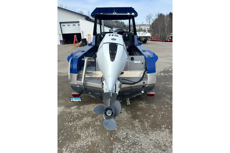 Slide: The Image of 2021 Stabicraft 1850 SuperCab with outboard motor, parked outdoors. - 2