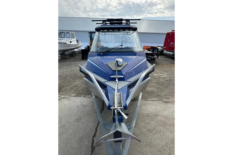 Slide: The Image of 2021 Stabicraft 1850 SuperCab boat, blue exterior, parked on a trailer. - 6
