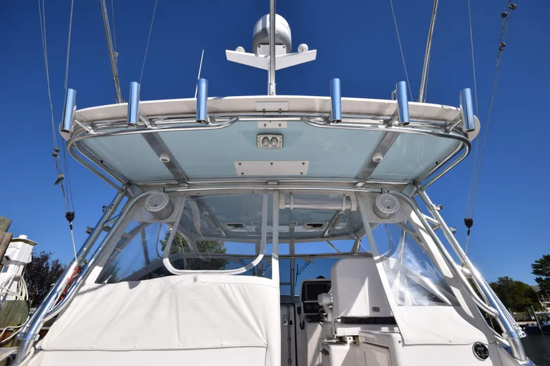 Slide: The Image of 2009 Jupiter 39 Express boat with sleek design and modern features, docked under clear blue sky. - 13