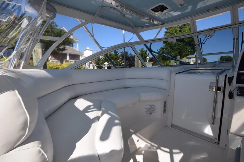 Slide: The Image of Interior of 2009 Jupiter 39 Express boat with white seating and panoramic windows. - 15