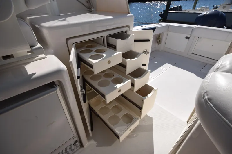 Slide: The Image of 2009 Jupiter 39 Express boat interior with open storage drawers and cup holders. - 16