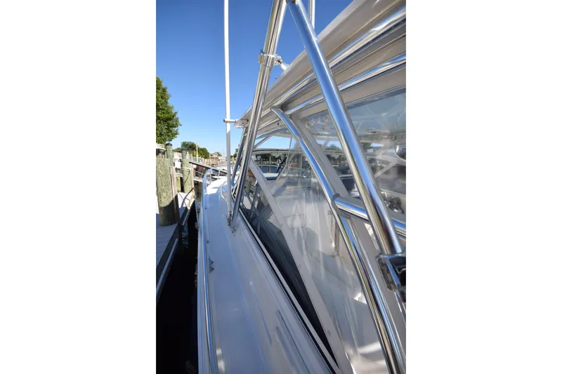 Slide: The Image of 2009 Jupiter 39 Express yacht docked, showcasing sleek design and polished metalwork. - 18