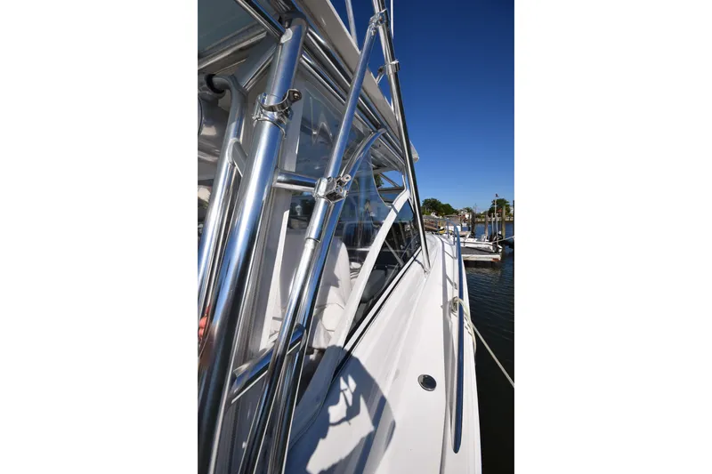 Slide: The Image of 2009 Jupiter 39 Express boat with sleek chrome details and clear blue sky. - 19