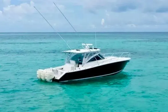 Slide: The Image of 2009 Jupiter 39 Express boat on turquoise ocean water under a cloudy sky. - 2